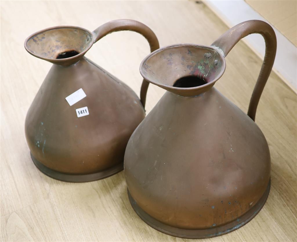 Two graduated copper jugs, one two gallon and other four gallon jugs